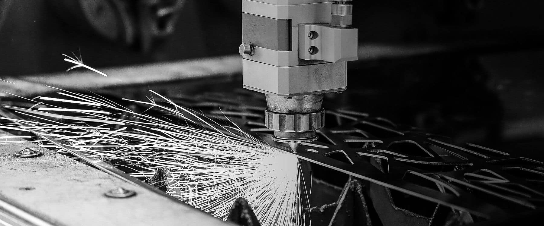 SIXPRO's 60KW fiber laser mid-cut, with a completed nest of profiled parts alongside